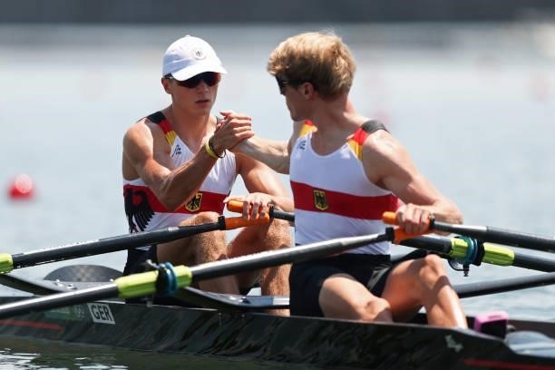 Jonathan Rommelmann and Jason Osborne of Team Germany clasp hands prior to the Lightweight Men's Double Sculls Heat 1 on day one of the Tokyo 2020...