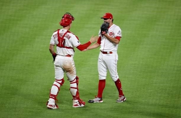 Heath Hembree of the Cincinnati Reds celebrates with Tyler Stephenson after the 6-5 win over the St. Louis Cardinals at Great American Ball Park on...