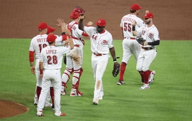 Aristides Aquino of the Cincinnati Reds celebrates with teammates after the 6-5 win over the St. Louis Cardinals at Great American Ball Park on July...