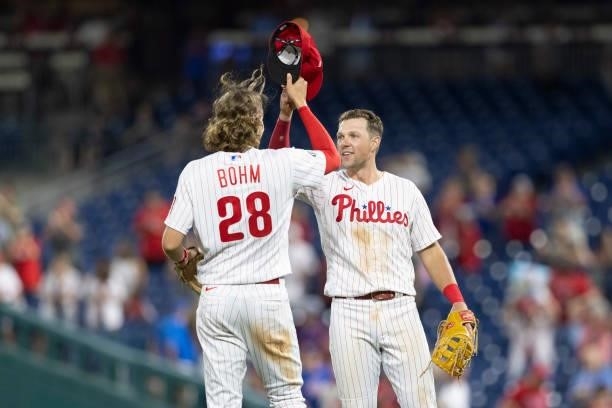 Alec Bohm of the Philadelphia Phillies celebrates with Rhys Hoskins after defeating the Atlanta Braves at Citizens Bank Park on July 23, 2021 in...