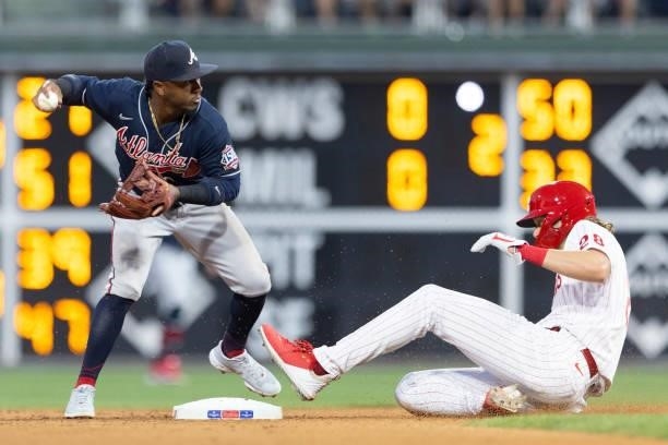 Ozzie Albies of the Atlanta Braves attempts to turn a double play against Alec Bohm of the Philadelphia Phillies at Citizens Bank Park on July 23,...