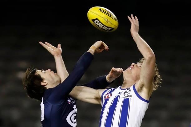 Lachie Plowman of the Blues and Nick Larkey of the Kangaroos compete during the round 19 AFL match between Carlton Blues and North Melbourne...