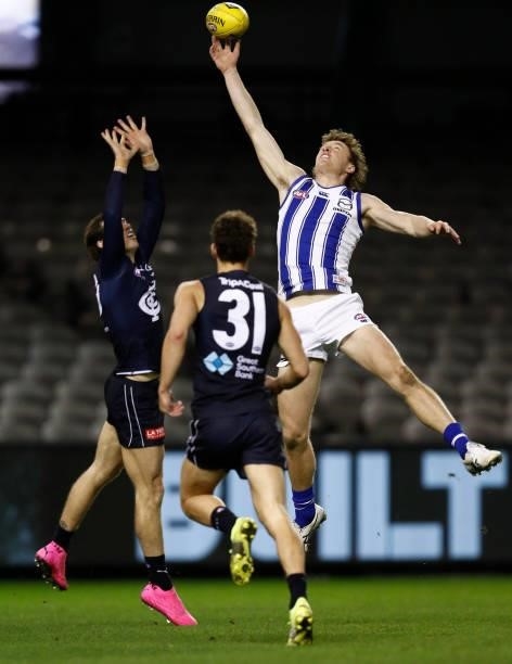 Lachie Plowman of the Blues and Nick Larkey of the Kangaroos compete during the round 19 AFL match between Carlton Blues and North Melbourne...