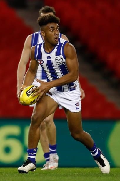 Atu Bosenavulagi of the Kangaroos runs with the ball during the round 19 AFL match between Carlton Blues and North Melbourne Kangaroos s at Marvel...