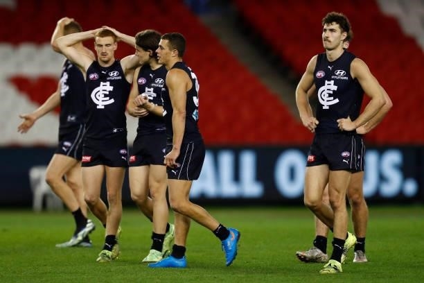 Dejected Carlton players walk from the ground after the round 19 AFL match between Carlton Blues and North Melbourne Kangaroos s at Marvel Stadium on...
