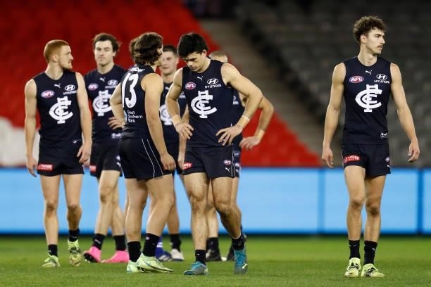 Dejected Carlton players walk from the ground after the round 19 AFL match between Carlton Blues and North Melbourne Kangaroos s at Marvel Stadium on...