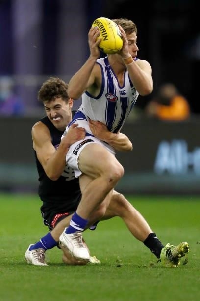 Tom Williamson of the Blues tackles Trent Dumont of the Kangaroos during the round 19 AFL match between Carlton Blues and North Melbourne Kangaroos s...