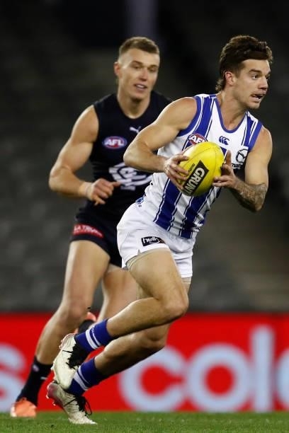 Jy Simpkin of the Kangaroos runs with the ball during the round 19 AFL match between Carlton Blues and North Melbourne Kangaroos s at Marvel Stadium...