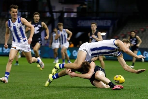Benjamin McKay of the Kangaroos twists his ankle in a collision with Jack Newnes of the Blues during the round 19 AFL match between Carlton Blues and...