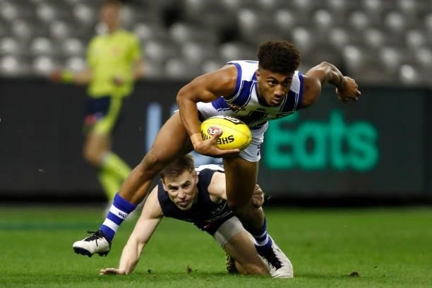 Atu Bosenavulagi of the Kangaroos breaks a tackle during the round 19 AFL match between Carlton Blues and North Melbourne Kangaroos s at Marvel...