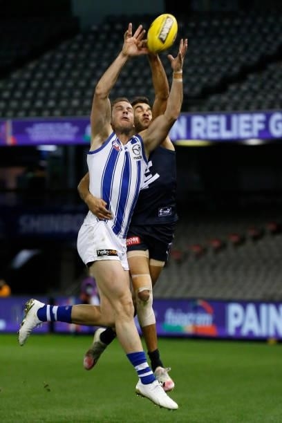 Jack Martin of the Blues spoils Josh Walker of the Kangaroos during the round 19 AFL match between Carlton Blues and North Melbourne Kangaroos s at...