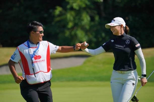 Asuka Kashiwabara of Japan fist bumps with her caddie after the birdie on the 8th green during the third round of Daito Kentaku eHeyanet Ladies at...