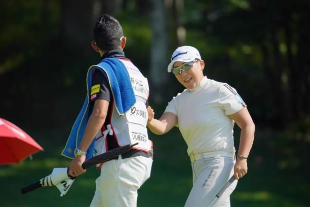 Jiyai Shin of South Korea fist bumps with her caddie after the birdie on the 9th green during the third round of Daito Kentaku eHeyanet Ladies at...