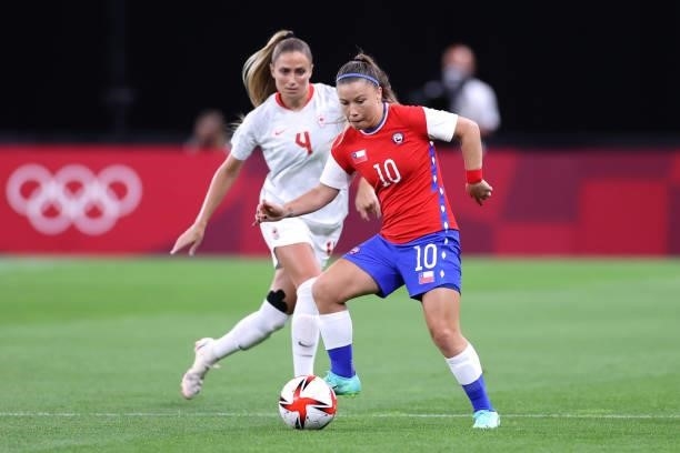 Yanara Aedo of Team Chile controls the ball whilst under pressure from Shelina Zadorsky of Team Canada during the Women's First Round Group E match...
