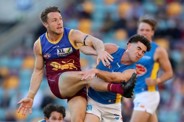 Lincoln McCarthy of the Lions kicks the ball under defensive pressure during the round 20 AFL match between Brisbane Lions and Gold Coast Suns at The...