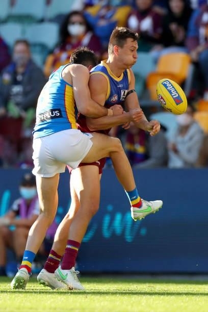 Hugh McCluggage of the Lions handballs during the round 20 AFL match between Brisbane Lions and Gold Coast Suns at The Gabba on July 24, 2021 in...