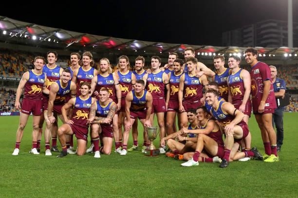 Brisbane players celebrate with Q Clash trophy during the round 20 AFL match between Brisbane Lions and Gold Coast Suns at The Gabba on July 24, 2021...
