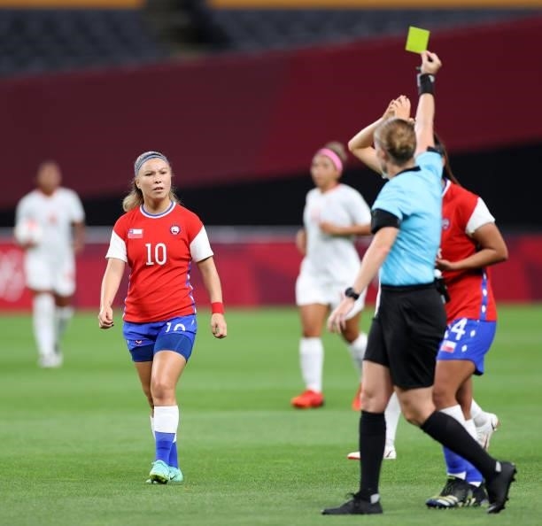 Yanara Aedo of Team Chile is shown a yellow card by Match Referee, Esther Staubli during the Women's First Round Group E match between Chile and...