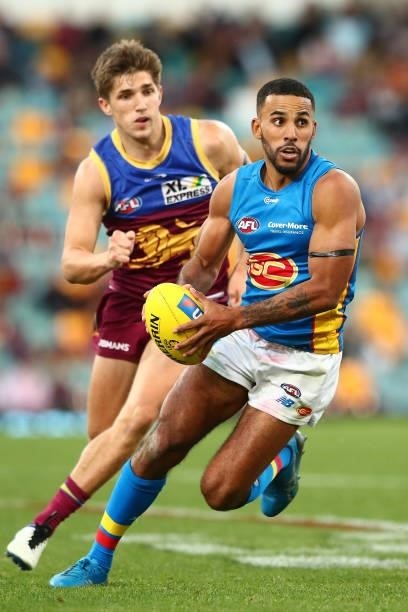 Touk Miller of the Suns handballs during the round 20 AFL match between Brisbane Lions and Gold Coast Suns at The Gabba on July 24, 2021 in Brisbane,...