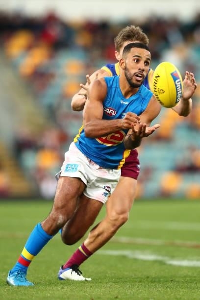 Touk Miller of the Suns handballs during the round 20 AFL match between Brisbane Lions and Gold Coast Suns at The Gabba on July 24, 2021 in Brisbane,...