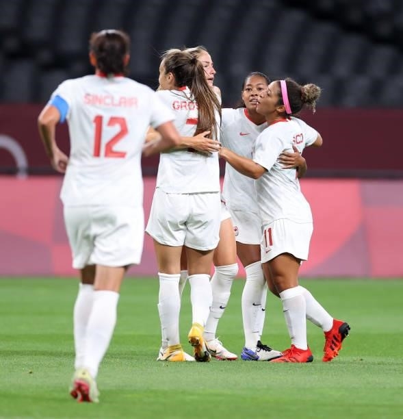 Janine Beckie of Team Canada celebrates with teammates after scoring their side's first goal during the Women's First Round Group E match between...