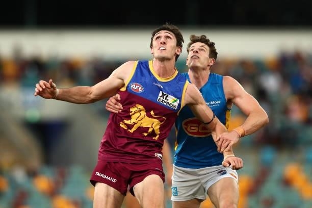 Oscar McInerney of the Lions and Chris Burgess of the Suns compete for the ball during the round 20 AFL match between Brisbane Lions and Gold Coast...