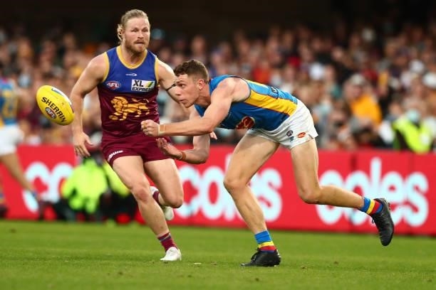 Josh Corbett of the Suns handballs during the round 20 AFL match between Brisbane Lions and Gold Coast Suns at The Gabba on July 24, 2021 in...