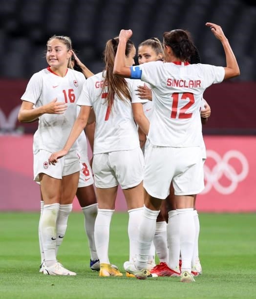 Janine Beckie of Team Canada celebrates with teammates after scoring their side's first goal during the Women's First Round Group E match between...