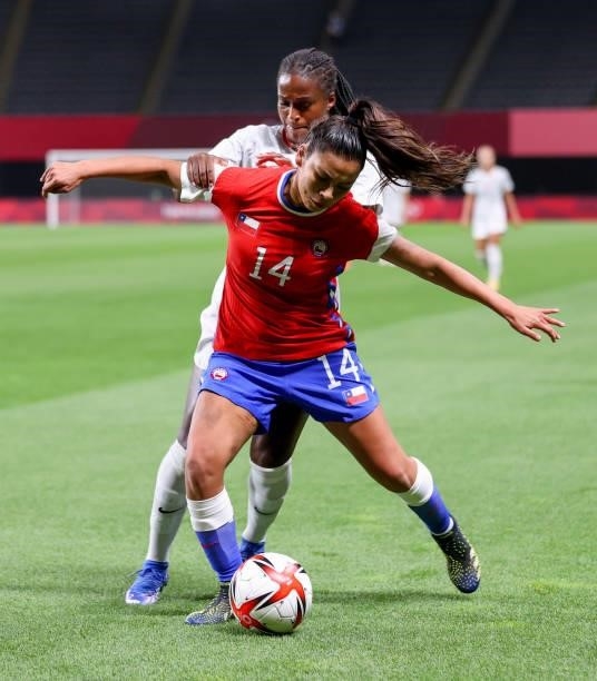 Daniela Pardo of Team Chile shields the ball from Nichelle Prince of Team Canada during the Women's First Round Group E match between Chile and...