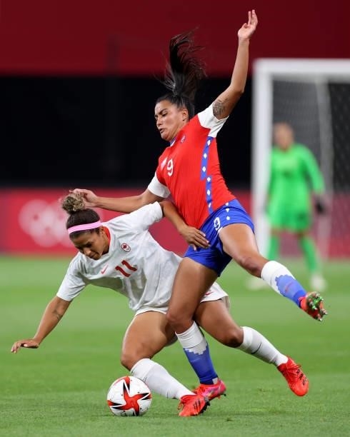 Desiree Scott of Team Canada holds off Jose Urrutia Maria of Team Chile during the Women's First Round Group E match between Chile and Canada on day...