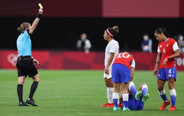 Desiree Scott of Team Canada is shown a yellow card by Match Referee, Esther Staubli during the Women's First Round Group E match between Chile and...