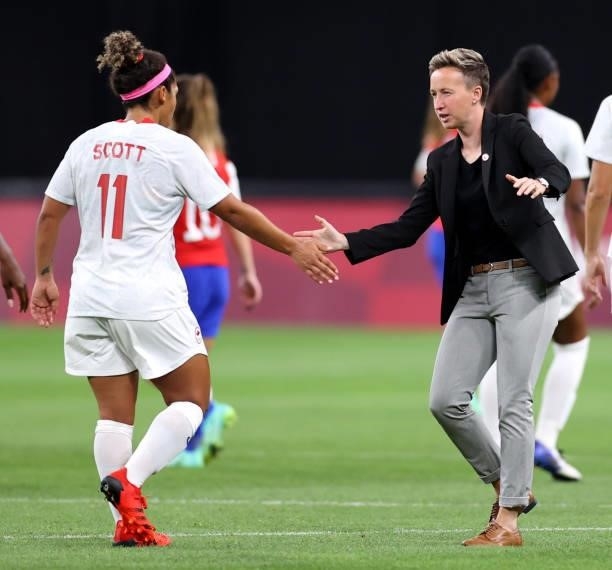 Bev Priestman, Head Coach of Team Canada celebrates with Desiree Scott of Team Canada after victory in the Women's First Round Group E match between...