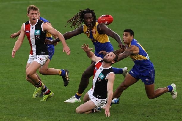 Brad Crouch of the Saints contests for the ball against Nic Naitanui and Tim Kelly of the Eagles during the round 19 AFL match between West Coast...