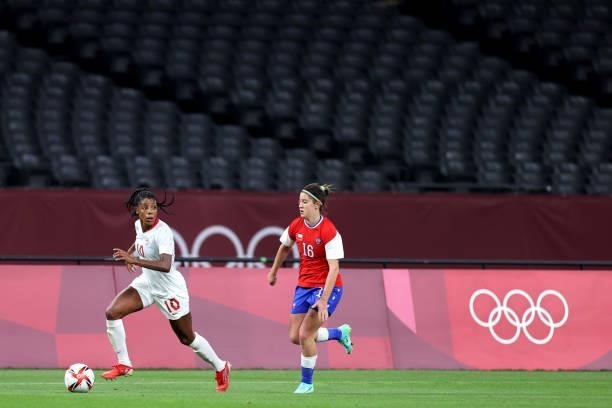 Ashley Lawrence of Team Canada runs with the ball whilst under pressure from Rosario Balmaceda of Team Chile as empty seats are seen during the...