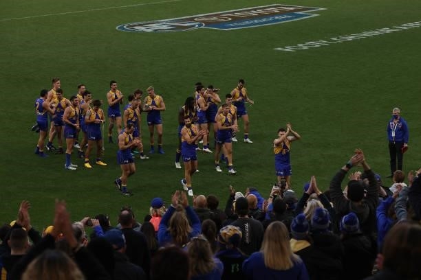 Jeremy McGovern of the Eagles leads the team from the field after winning and playing his 150th game during the round 19 AFL match between West Coast...