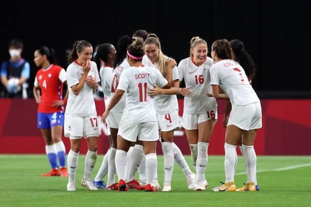 Janine Beckie of Team Canada celebrates with teammates after scoring their side's second goal during the Women's First Round Group E match between...