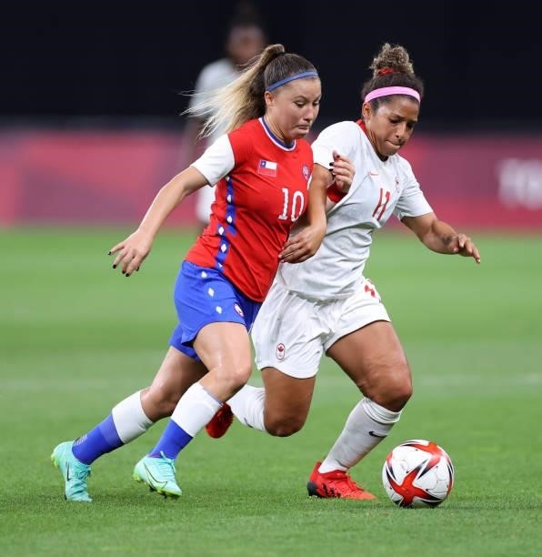 Yanara Aedo of Team Chile battles for possession with Desiree Scott of Team Canada during the Women's First Round Group E match between Chile and...