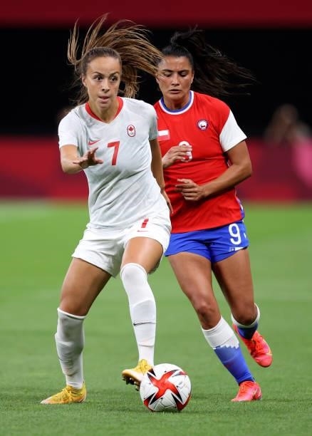 Julia Grosso of Team Canada runs with the ball whilst under pressure from Jose Urrutia Maria of Team Chile during the Women's First Round Group E...