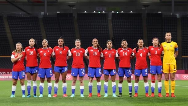 Players of Team Chile stand for the national anthem prior to the Women's First Round Group E match between Chile and Canada on day one of the Tokyo...