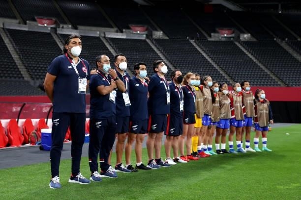 Jose Letelier, Head Coach of Team Chile and his staff stand for the national anthem prior to the Women's First Round Group E match between Chile and...