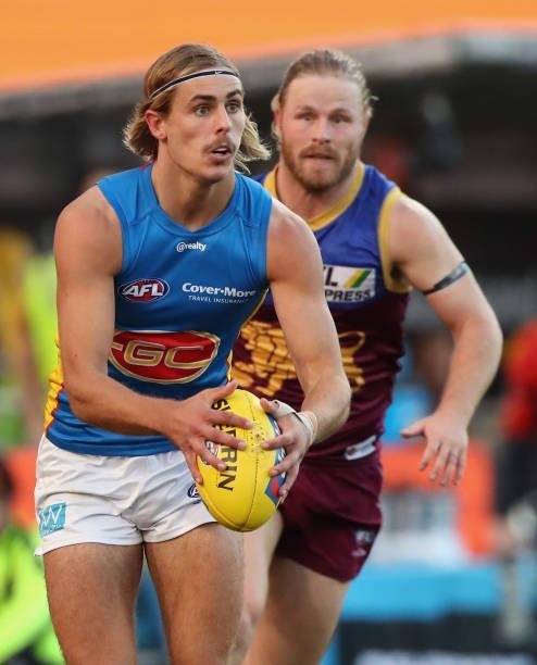 Jeremy Sharp of the Suns runs with the ball during the round 20 AFL match between Brisbane Lions and Gold Coast Suns at The Gabba on July 24, 2021 in...