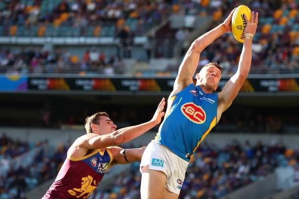 Josh Corbett of the Suns marks the ball during the round 20 AFL match between Brisbane Lions and Gold Coast Suns at The Gabba on July 24, 2021 in...