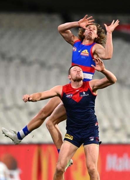 Aaron Naughton of the Bulldogs attempts to mark over Steven May of the Demons during the round 20 AFL match between Melbourne Demons and Western...