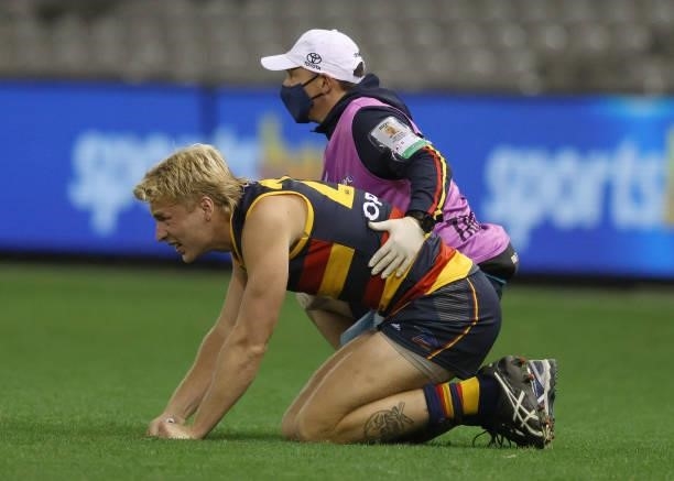 Billy Frampton of the Crows is seen with the trainer during the round 20 AFL match between Adelaide Crows and Hawthorn Hawks at Marvel Stadium on...