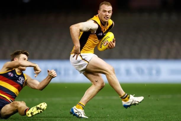 Tom Mitchell of the Hawks breaks a tackle attempt from Paul Seedsman of the Crows during the round 20 AFL match between Adelaide Crows and Hawthorn...