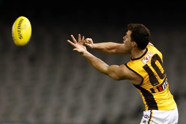 Jaeger O'Meara of the Hawks handballs during the round 20 AFL match between Adelaide Crows and Hawthorn Hawks at Marvel Stadium on July 24, 2021 in...