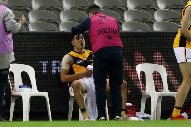 Tyler Brockman of the Hawks receives medical attention from the bench during the round 20 AFL match between Adelaide Crows and Hawthorn Hawks at...