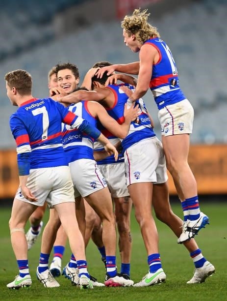 Jamarra Ugle-Hagan of the Bulldogs is congratulated by team mates after kicking a goal during the round 20 AFL match between Melbourne Demons and...