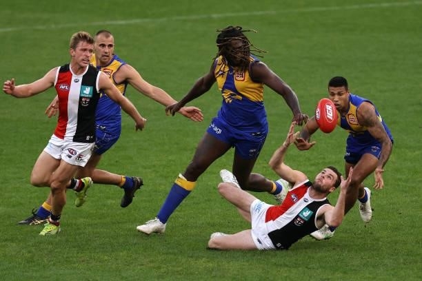 Brad Crouch of the Saints contests for the ball against Nic Naitanui and Tim Kelly of the Eagles during the round 19 AFL match between West Coast...