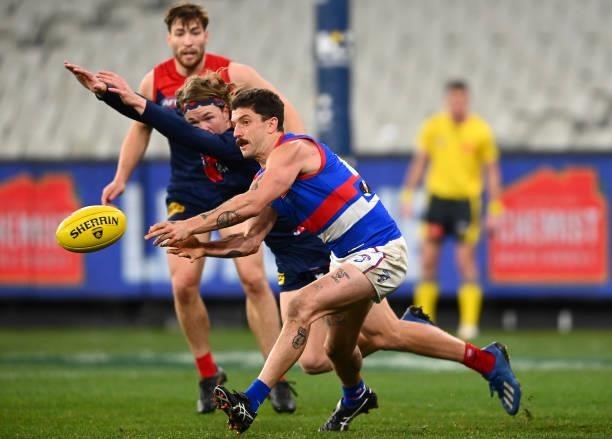 Tom Liberatore of the Bulldogs handballs during the round 20 AFL match between Melbourne Demons and Western Bulldogs at Melbourne Cricket Ground on...